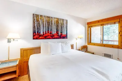 a bedroom with a white bed and a window at Master Units 18A & B at Granlibakken in Tahoe City