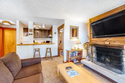 a living room with a couch and a fireplace at Master Units 18A & B at Granlibakken in Tahoe City
