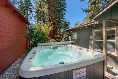 a hot tub in the backyard of a house at Manzanita Holiday in South Lake Tahoe