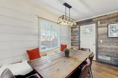 a dining room with a wooden table and chairs at Manzanita Holiday in South Lake Tahoe