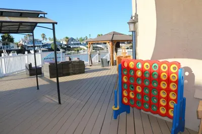 a colorful object sitting on a deck next to a building at Bellanca in Discovery Bay