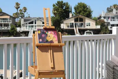 a suitcase sitting on a chair next to a fence at Bellanca in Discovery Bay