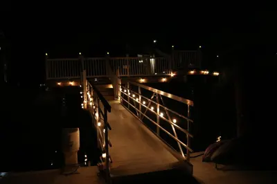 a boardwalk with lights on it at night at Bellanca in Discovery Bay