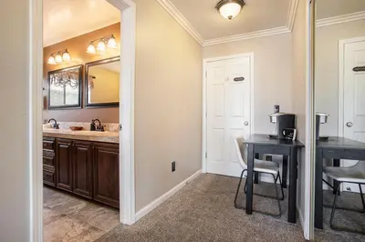 a kitchen with a sink and a table and a mirror at Bellanca in Discovery Bay