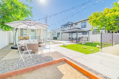 a patio with an umbrella and a chair and a table at Urban Haven in Reno: Charming Studio Retreat in Reno