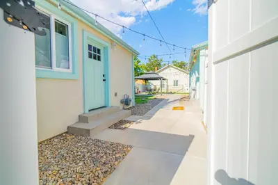a house with a blue door and a sidewalk at Urban Haven in Reno: Charming Studio Retreat in Reno