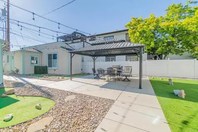 a patio with a table and chairs under a pergola at Reno Dream Cottage: Delightful 2-Bedroom Sanctuary in Reno