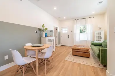 a living room with a table and chairs and a couch at Reno Dream Cottage: Delightful 2-Bedroom Sanctuary in Reno