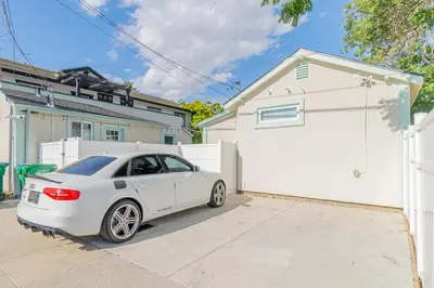 a white car parked in front of a white garage at Reno Oasis: Stylish 1-Bedroom Escape in Reno