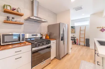 a kitchen with a stainless steel refrigerator and a stove at Reno Oasis: Stylish 1-Bedroom Escape in Reno