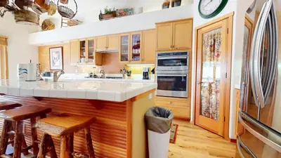 a kitchen with wooden cabinets and a counter top at Snowcreek V #757 condo in Mammoth Lakes