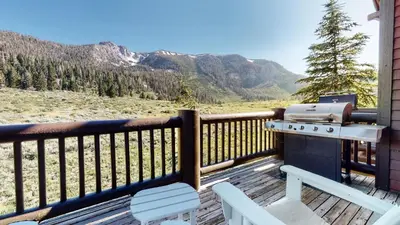 a grill on the deck of a house with mountains at Snowcreek V #757 condo in Mammoth Lakes