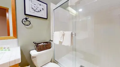 a bathroom with a toilet and a glass shower at Snowcreek V #757 condo in Mammoth Lakes
