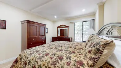a bedroom with a bed and a dresser and a window at Summit #245 condo in Mammoth Lakes
