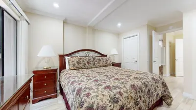 a bedroom with a bed and a dresser and a window at Summit #245 condo in Mammoth Lakes