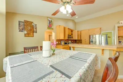 a kitchen with a table and a ceiling fan at Porterville Getaway with Patio and Valley Views! in Porterville