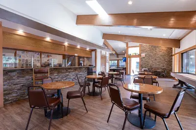 a restaurant with tables and chairs and a bar at Club Tahoe Resort in Incline Village