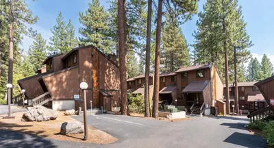 a house in the woods with a parking lot at Club Tahoe Resort in Incline Village