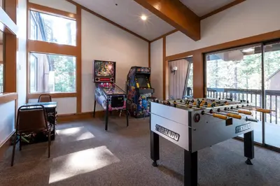 a room with two arcade games and a table at Club Tahoe Resort in Incline Village