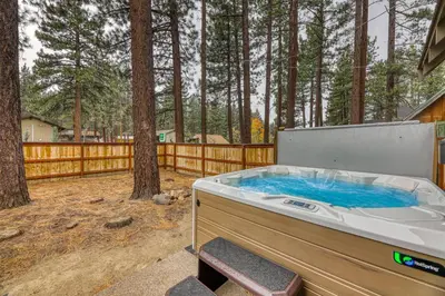 a hot tub in a backyard with trees at Black Bear Hideaway in South Lake Tahoe