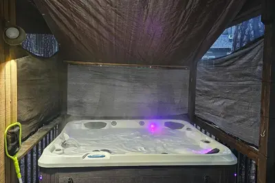 a bath tub with a purple light in a room at Cresta Cabin in Arnold