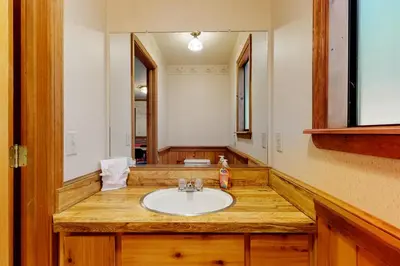 a bathroom with a sink and a mirror at Cresta Cabin in Arnold