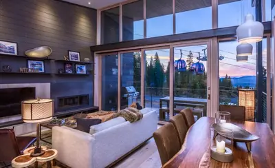 a living room with a couch and a table at Modern Ski In-Out Home, Mid-Mountain in Truckee