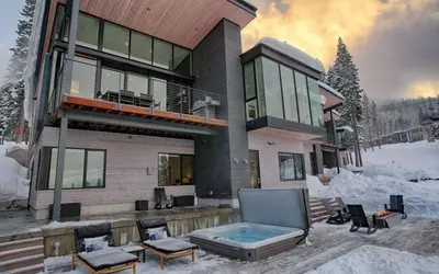 a house with a hot tub in the snow at Modern Ski In-Out Home, Mid-Mountain in Truckee
