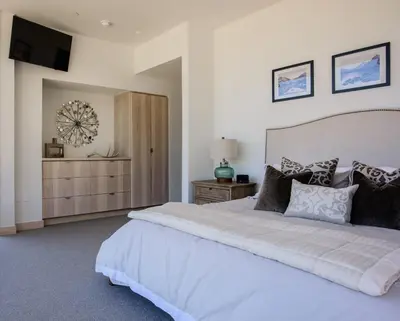 a bedroom with a large bed and a television at Modern Ski In-Out Home, Mid-Mountain in Truckee