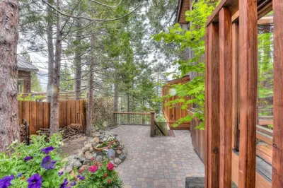 a home for sale in the woods with a walkway at Crystal Bay Lakeview in Crystal Bay