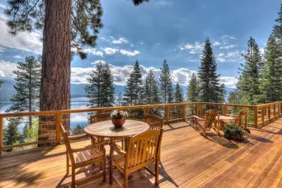 a deck with a table and chairs and a tree at Crystal Bay Lakeview in Crystal Bay