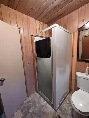 a bathroom with a shower and a toilet in a room at Moore's Cabin in Miramonte