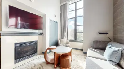 a living room with a couch and a table in front of a fireplace at Village Monache #720 condo in Mammoth Lakes