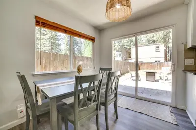 a dining room with a table and chairs and a window at half Mi to Lake Tahoe Pet-Friendly Cabin in South Lake Tahoe