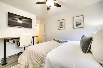 a bedroom with a white bed and a desk at half Mi to Lake Tahoe Pet-Friendly Cabin in South Lake Tahoe