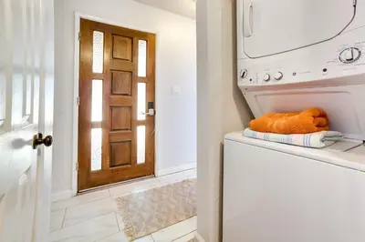 a laundry room with an open washer and dryer at half Mi to Lake Tahoe Pet-Friendly Cabin in South Lake Tahoe