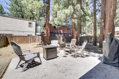 a patio with chairs and a table and a fence at half Mi to Lake Tahoe Pet-Friendly Cabin in South Lake Tahoe