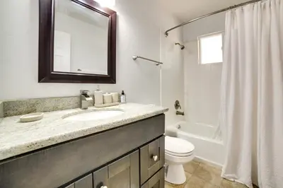 a bathroom with a sink and a toilet and a mirror at half Mi to Lake Tahoe Pet-Friendly Cabin in South Lake Tahoe