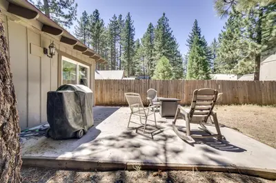 a patio with chairs and a trash can and a fence at half Mi to Lake Tahoe Pet-Friendly Cabin in South Lake Tahoe