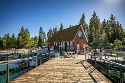 a wooden boardwalk leading to a barn with people on it at Brand New 3BDR Cabin 4 Min to Ski Resort and Beach in Tahoma