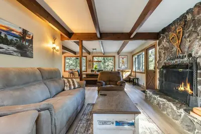 a living room with a couch and a fireplace at Brand New 3BDR Cabin 4 Min to Ski Resort and Beach in Tahoma