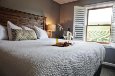 a bedroom with a large white bed with a window at Purple Orchid Resort & Spa in Livermore