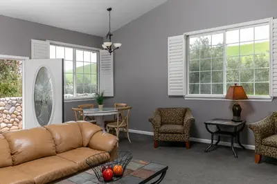 a living room with a couch and chairs and windows at Purple Orchid Resort & Spa in Livermore