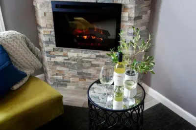 a glass table with wine glasses and a fireplace at Purple Orchid Resort & Spa in Livermore