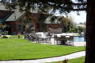 a patio with tables and chairs in front of a house at Purple Orchid Resort & Spa in Livermore