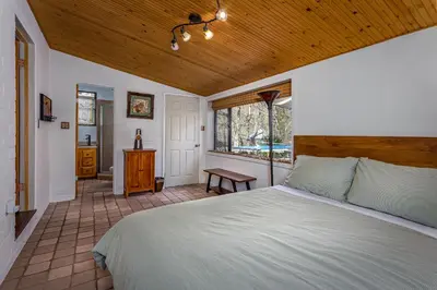a bedroom with a bed and a wooden ceiling at Magical River House ! 10 min to SNP park entrance in Three Rivers