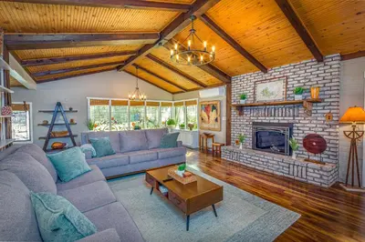 a living room with a couch and a fireplace at Magical River House ! 10 min to SNP park entrance in Three Rivers