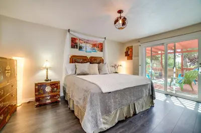 a bedroom with a bed and a sliding glass door at Pet-Friendly Home with Hot Tub! 6 Mi to Dtwn Reno in Reno