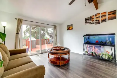 a living room with a couch and a fish tank at Pet-Friendly Home with Hot Tub! 6 Mi to Dtwn Reno in Reno