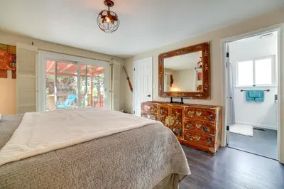 a bedroom with a bed and a mirror and a dresser at Pet-Friendly Home with Hot Tub! 6 Mi to Dtwn Reno in Reno